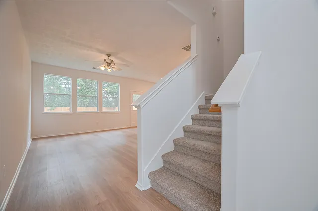 a view of empty room with wooden floor