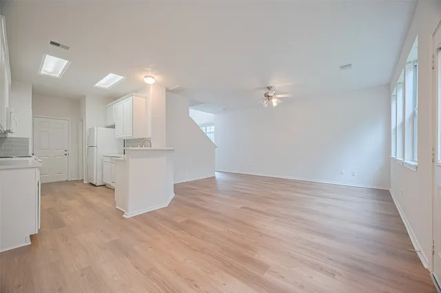 a kitchen with white cabinets and white appliances