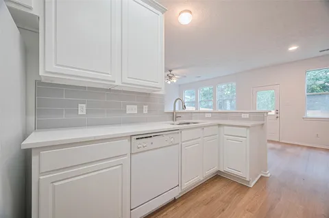 a kitchen with cabinets a sink and dishwasher