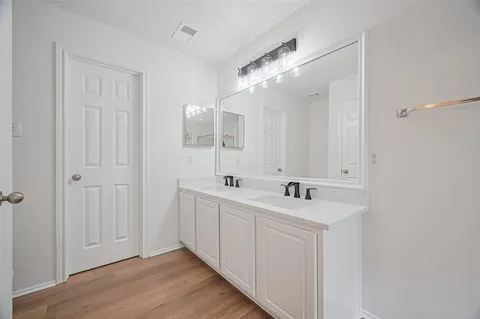 a white bath tub sitting next to a shower