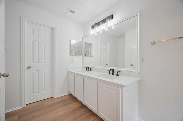 a white bath tub sitting next to a shower