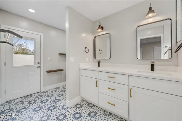 a bathroom with double sink and a mirror
