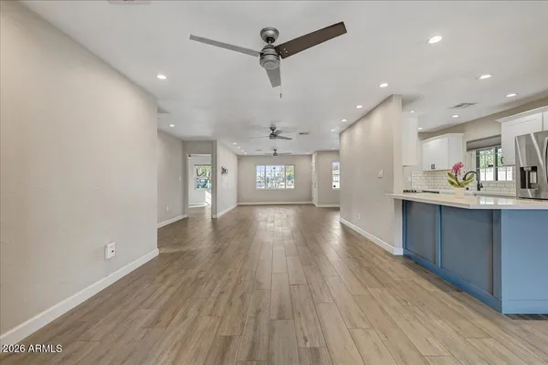 a view of a kitchen with a sink and a refrigerator