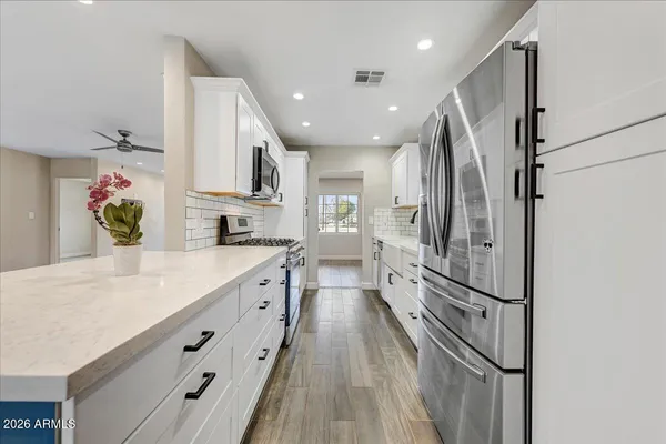 a kitchen with stainless steel appliances a refrigerator and a sink