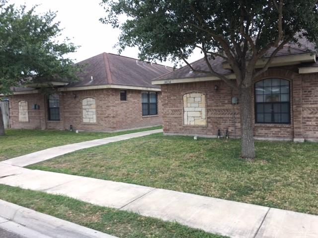 1404 East Quail Street Pharr, TX 78577 - Photo 2 of 12 a front view of a house with a garden