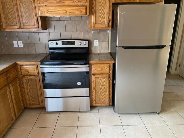 1404 East Quail Street Pharr, TX 78577 - Photo 3 of 12 a white refrigerator freezer and a stove sitting inside of a kitchen