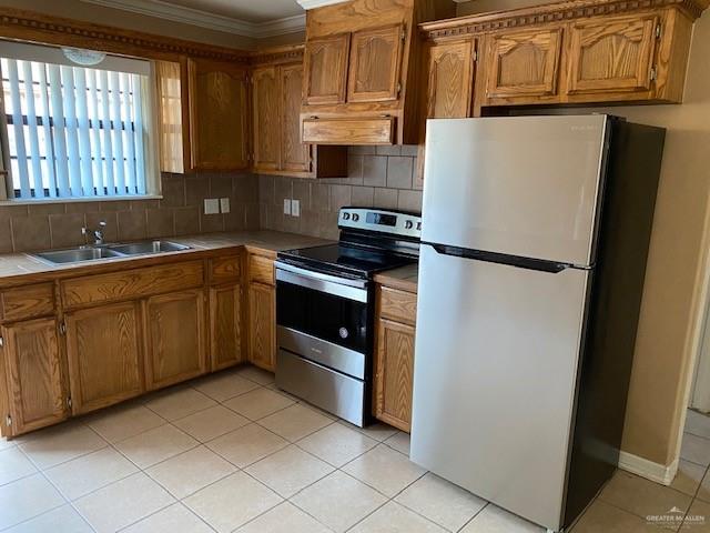 1404 East Quail Street Pharr, TX 78577 - Photo 5 of 12 a kitchen with stainless steel appliances a refrigerator sink and cabinets