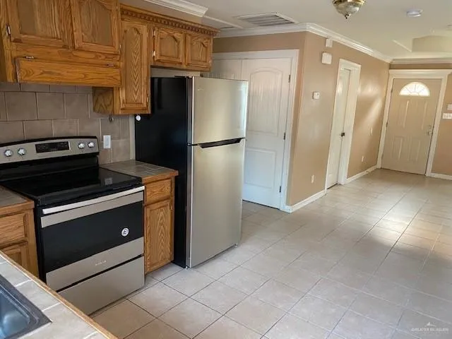 a kitchen with stainless steel appliances granite countertop a refrigerator and a stove
