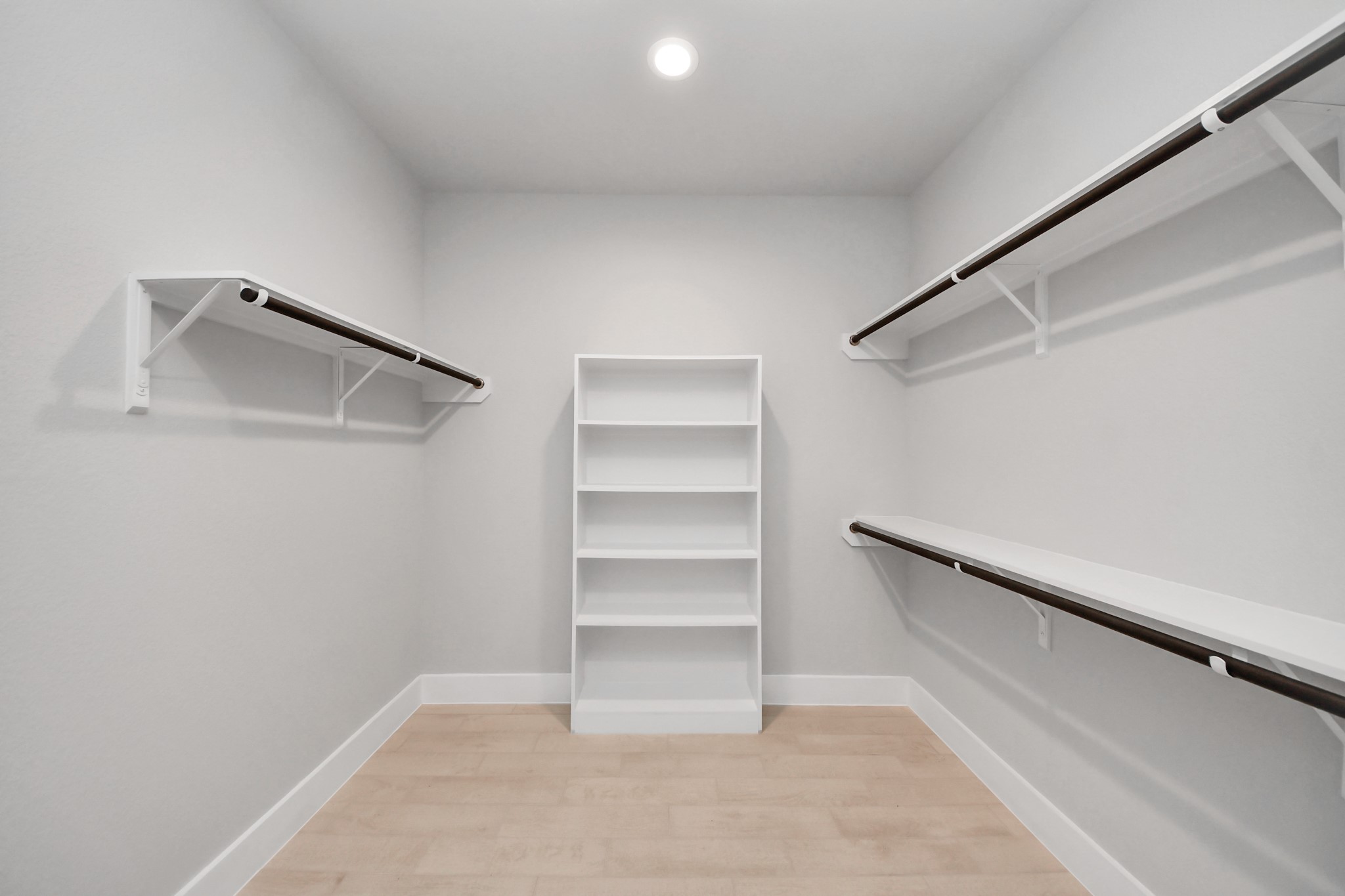 3043 Native Spg Drive Spring, TX 77373 - Photo 29 of 45 Walk-in closet that epitomizes luxury and practicality. This generously sized space features built-in shelving, offering abundant room for impeccable organization. High ceilings and recessed lighting create a bright and welcoming ambiance.