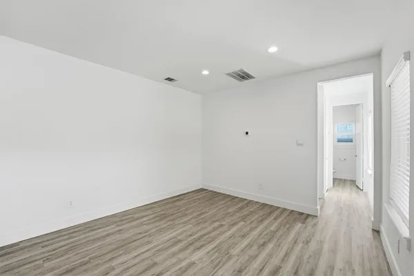 a view of a room with wooden floor