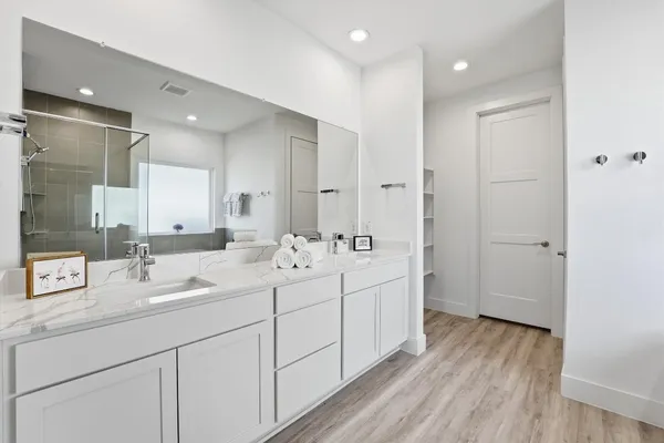 a bathroom with a double vanity sink and mirror