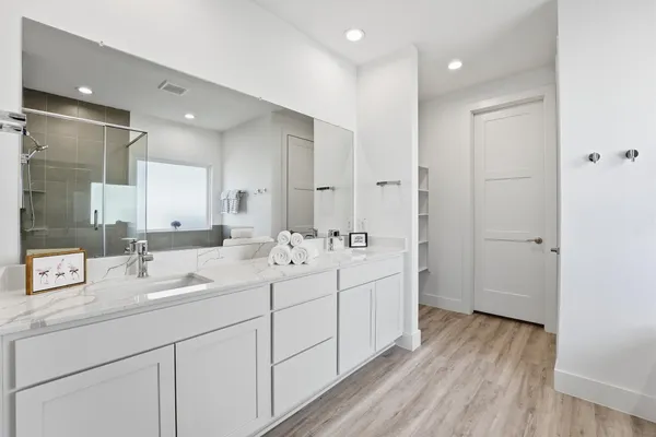 a bathroom with a double vanity sink and mirror