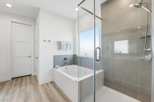 a bathroom with a tub and shower