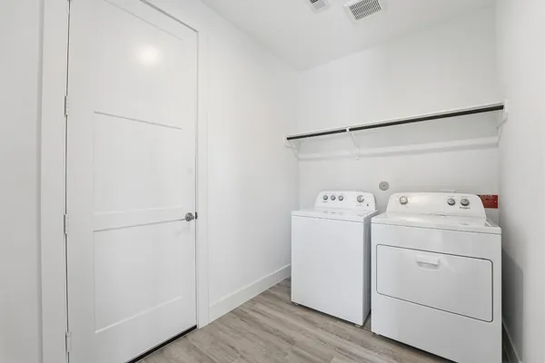 a view of storage and utility room with washer and dryer