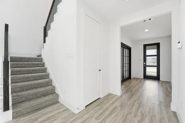 a view of an entryway with wooden floor