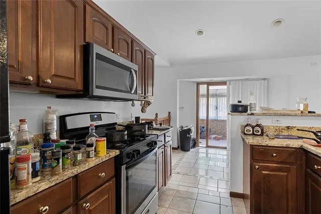 a kitchen with a stove microwave and sink