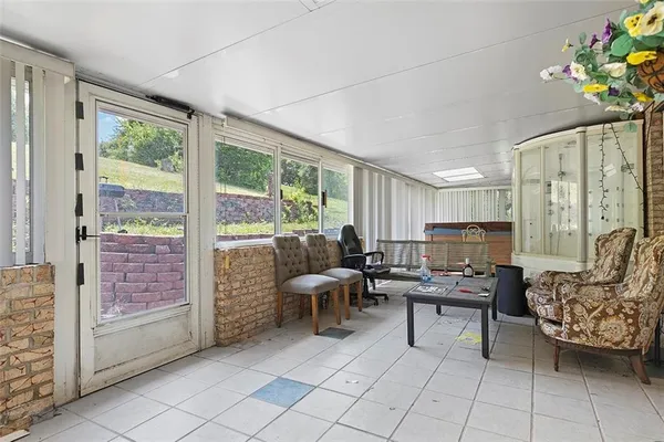 a living room with furniture and a floor to ceiling window