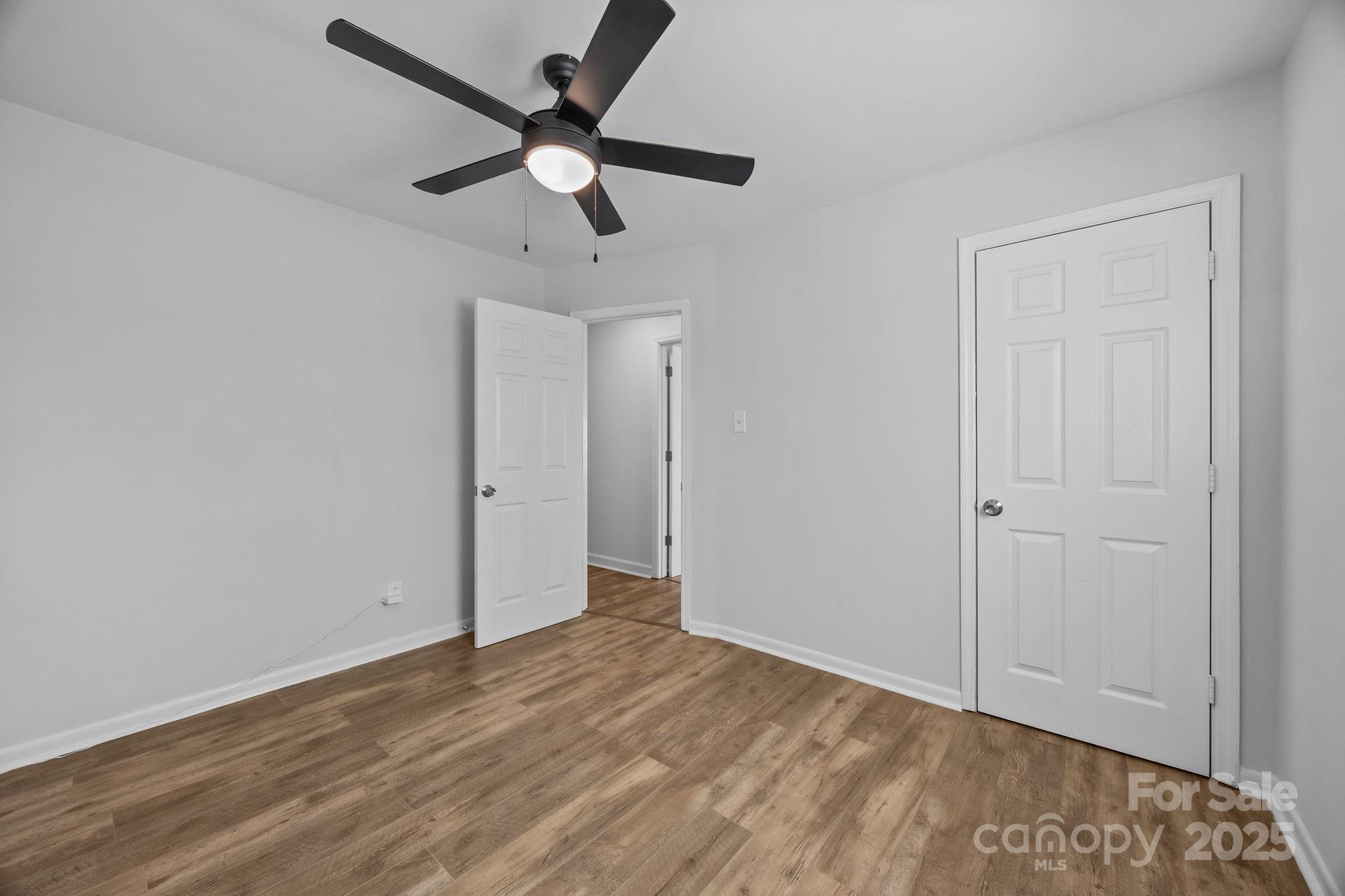 976 10 Oaks Drive Lancaster, SC 29720 - Photo 15 of 24 an empty room with wooden floor and ceiling fan