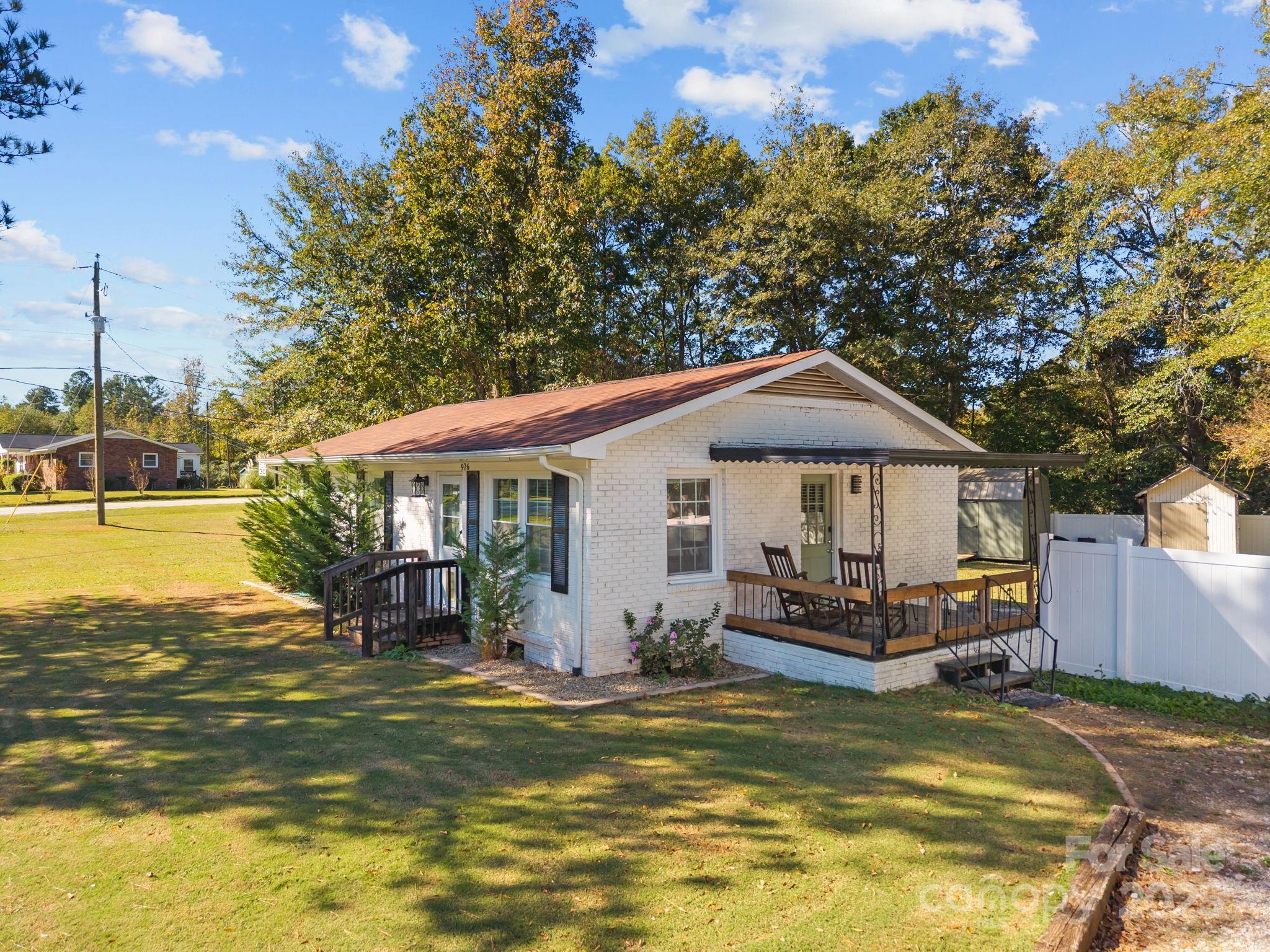 976 10 Oaks Drive Lancaster, SC 29720 - Photo 2 of 24 a front view of a house with swimming pool having outdoor seating