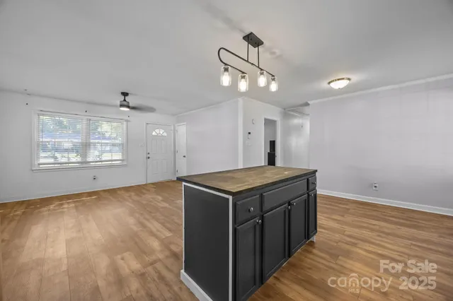 a kitchen with a stove and a wooden floor