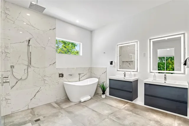 a bathroom with a white tub a vanity and a shower