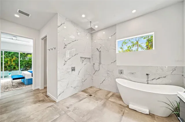 a white toilet sitting next to a white wall