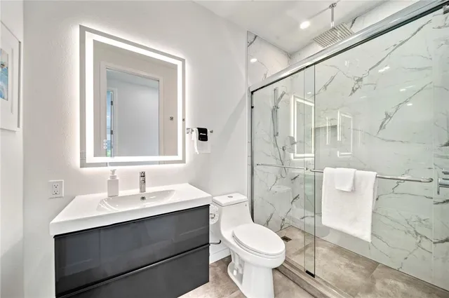 a bedroom with a bed and painting on the wall