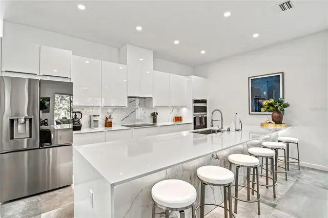a kitchen with a sink a counter and cabinets