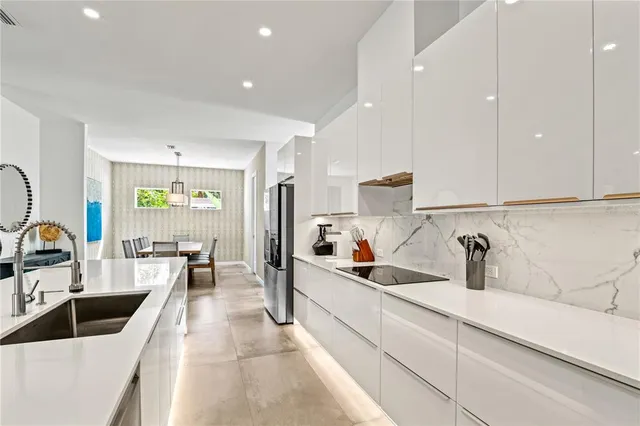 a kitchen with a table and chairs