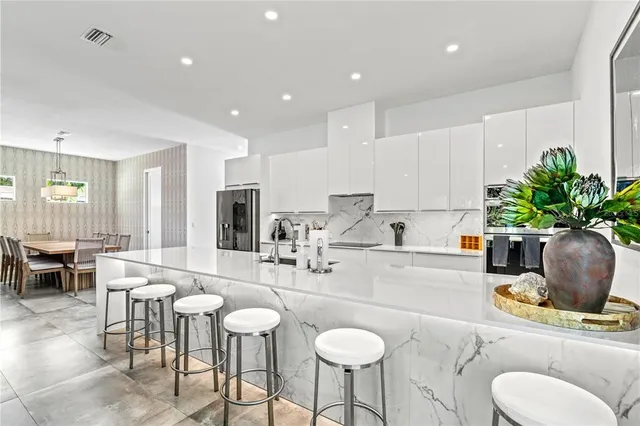 a living room with patio furniture and a large window