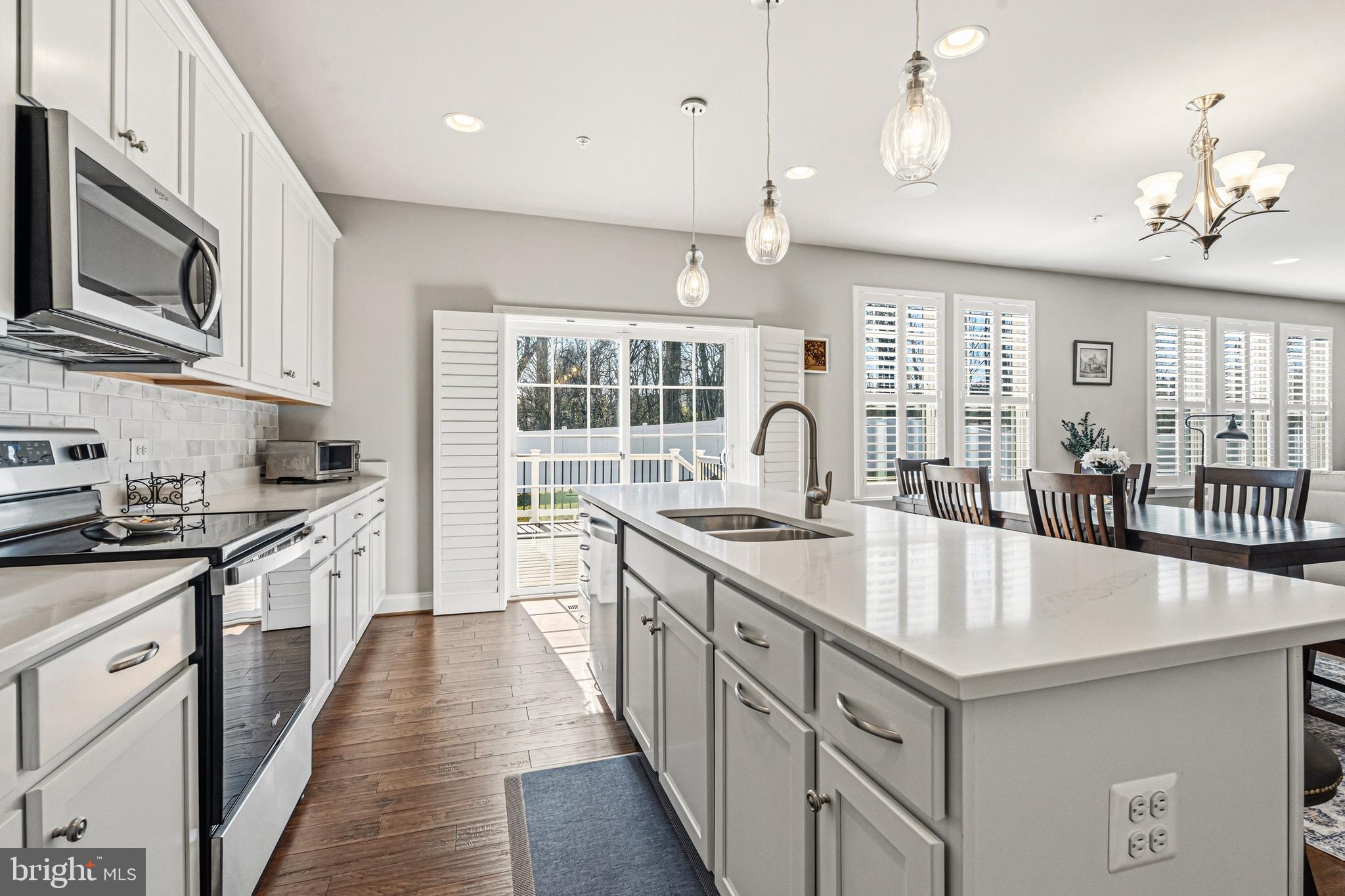 113 Harding Street Lutherville-Timonium, MD 21093 - Photo 11 of 45 a large kitchen with granite countertop a large center island a sink stainless steel appliances and cabinets