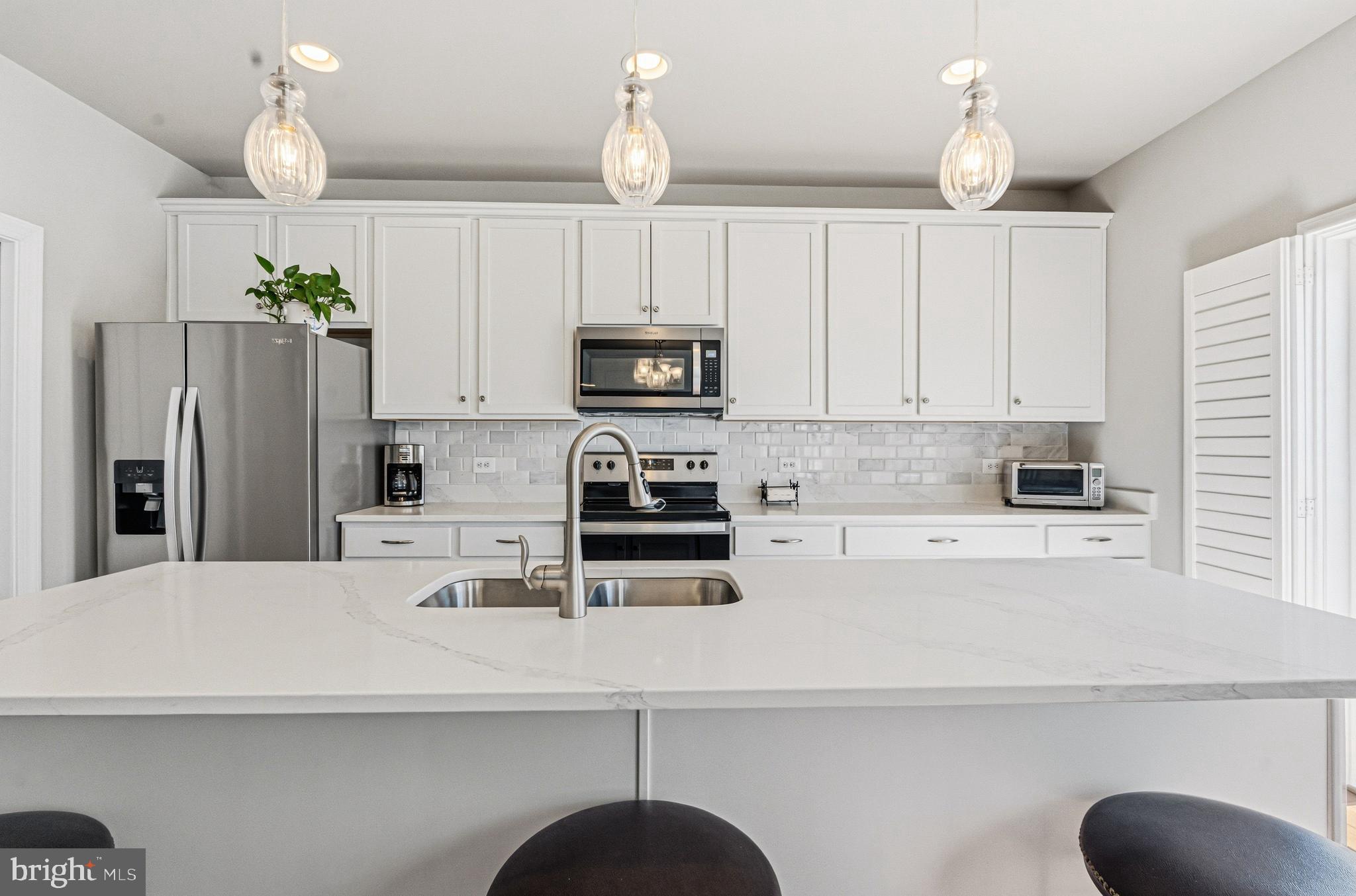 113 Harding Street Lutherville-Timonium, MD 21093 - Photo 14 of 45 a kitchen with kitchen island a refrigerator a stove a microwave and cabinets