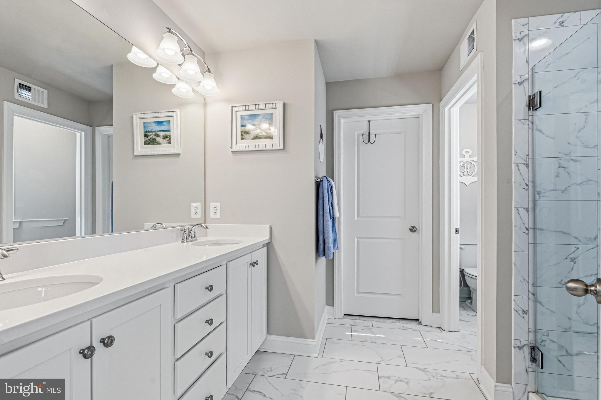 113 Harding Street Lutherville-Timonium, MD 21093 - Photo 28 of 45 a spacious bathroom with a shower sink and mirror