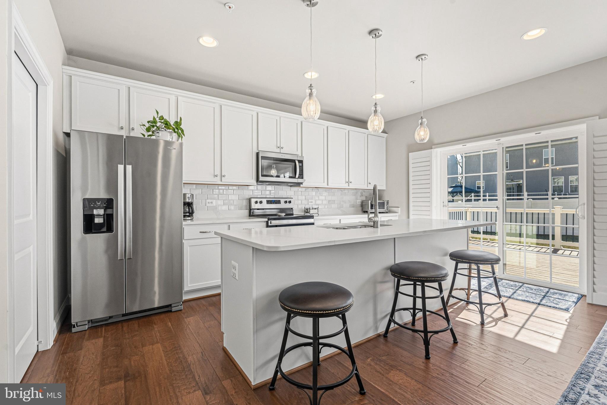113 Harding Street Lutherville-Timonium, MD 21093 - Photo 9 of 45 a kitchen with stainless steel appliances a dining table chairs refrigerator and sink