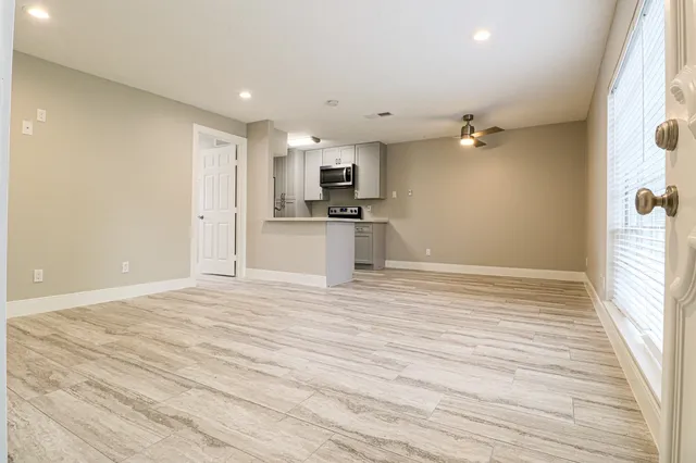 a view of a kitchen with a sink and a refrigerator