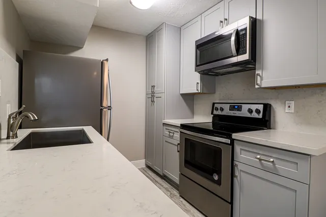 a kitchen with a stove and a microwave