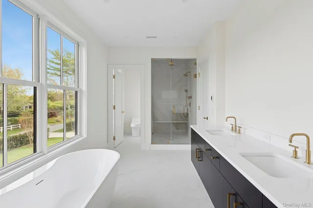 a spacious bathroom with sink shower and bathtub