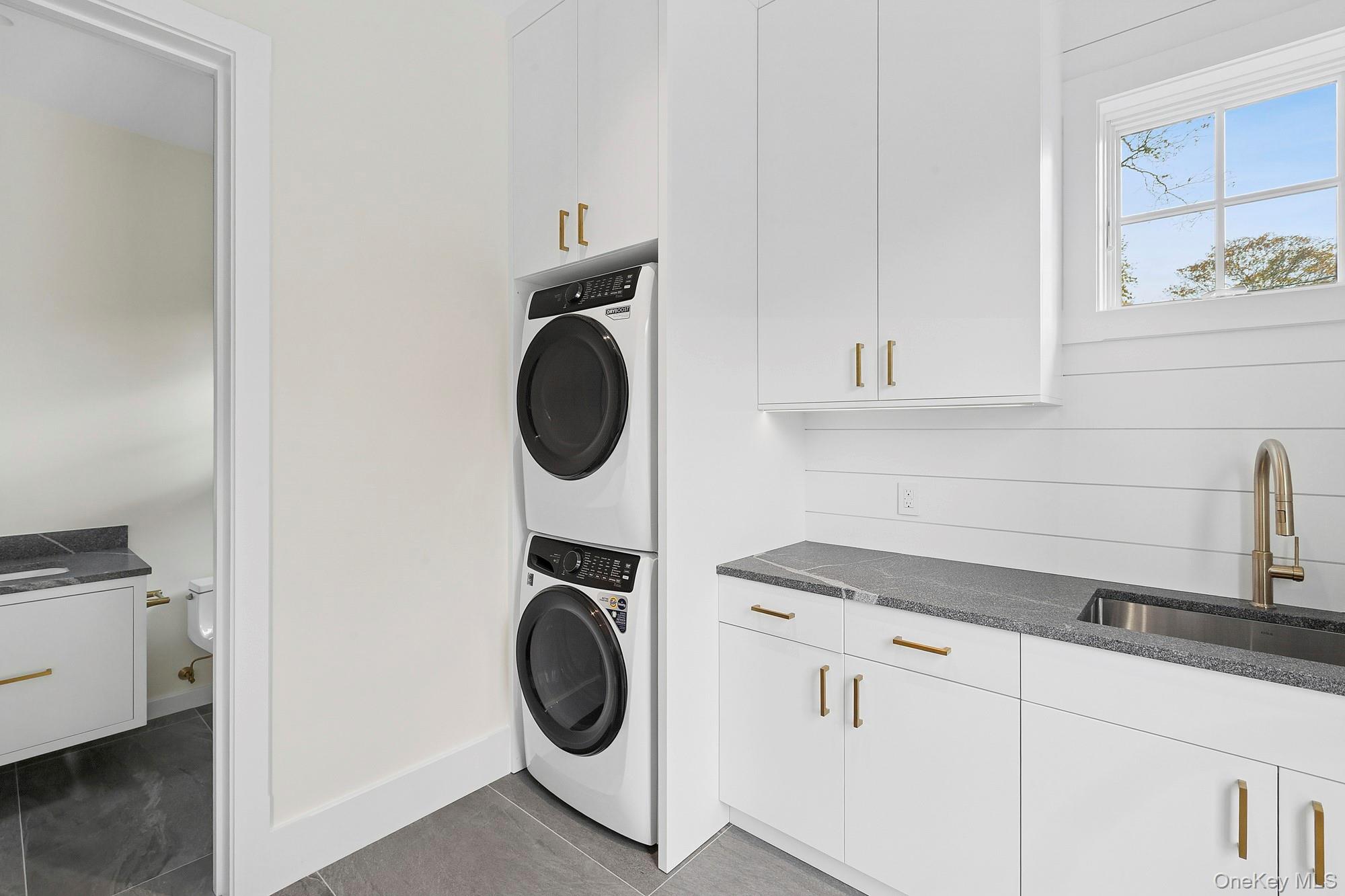 25 Liberty Street Westhampton Beach, NY 11978 - Photo 10 of 33 a utility room with sink dryer and washer