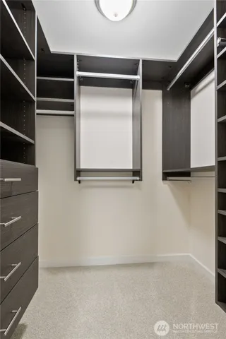 a view of walk in closet with empty racks