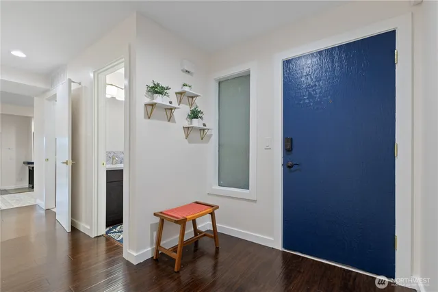 a view of a room with wooden floor and bench