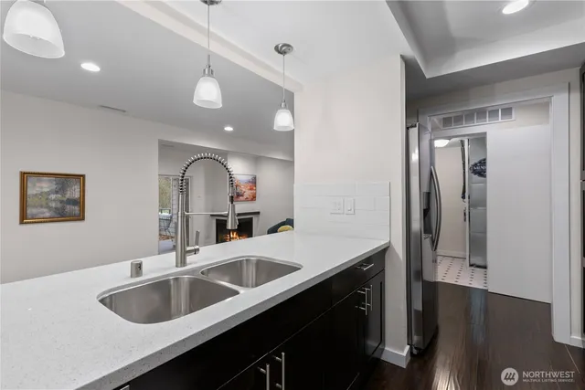 a kitchen with sink and refrigerator