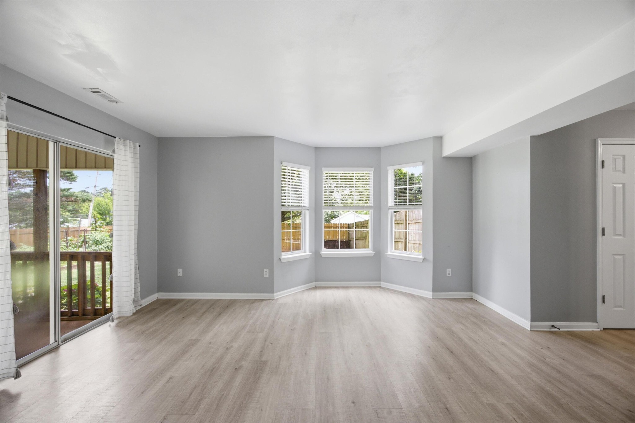 6729 Hickory Trace Circle Chattanooga, TN 37421 - Photo 7 of 30 an empty room with wooden floor and windows