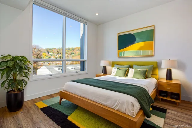 a bedroom with a bed and a potted plant