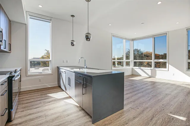 a kitchen with counter top space and wooden floor