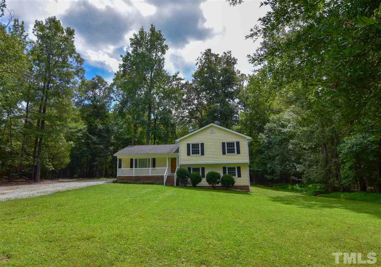 6354 Helena Moriah Road Rougemont, NC 27572 - Photo 2 of 21 a view of a house with a big yard and large trees