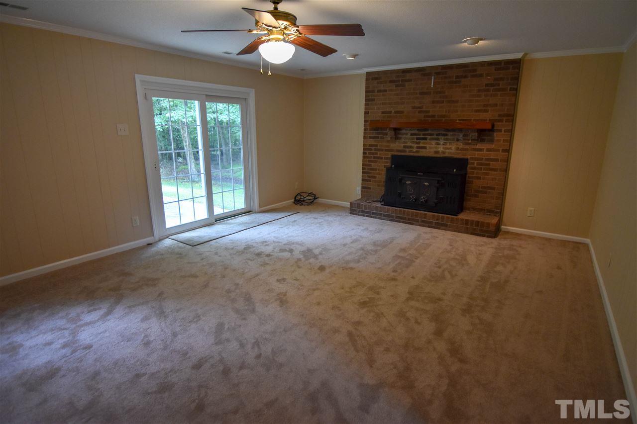 6354 Helena Moriah Road Rougemont, NC 27572 - Photo 4 of 21 an empty room with windows and fireplace