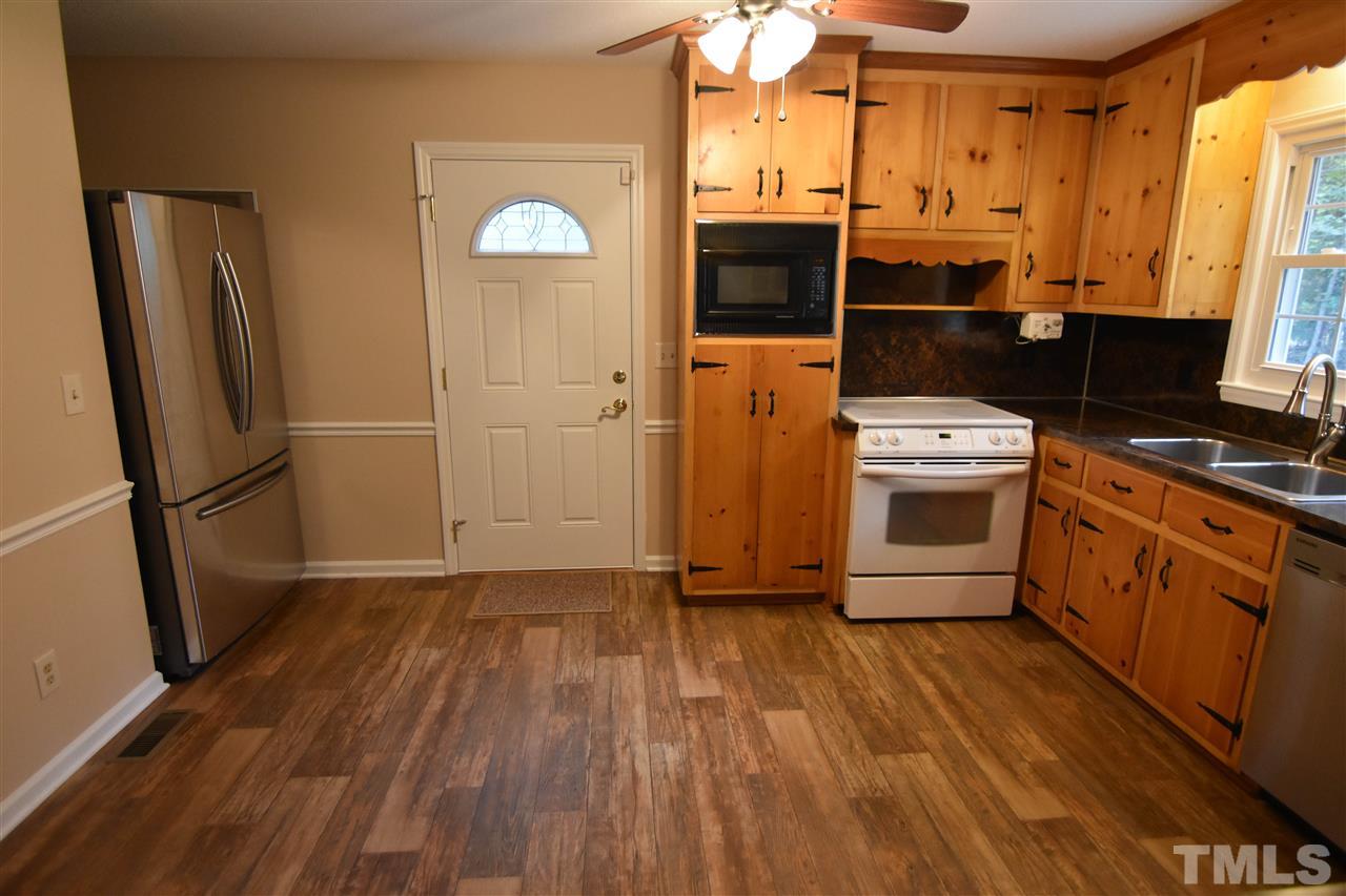 6354 Helena Moriah Road Rougemont, NC 27572 - Photo 8 of 21 a kitchen with stainless steel appliances a stove a refrigerator and cabinets