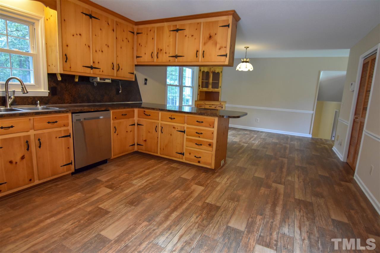 6354 Helena Moriah Road Rougemont, NC 27572 - Photo 9 of 21 a kitchen with stainless steel appliances a sink cabinets and wooden floor
