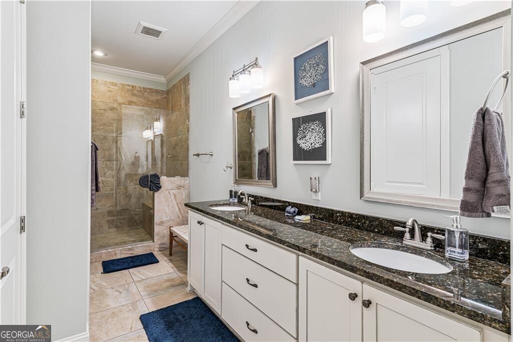 172 Turtle Track Lane, Unit OCEAN Jekyll Island, GA 31527 - Photo 16 of 51 a spacious bathroom with a granite countertop sink and a mirror