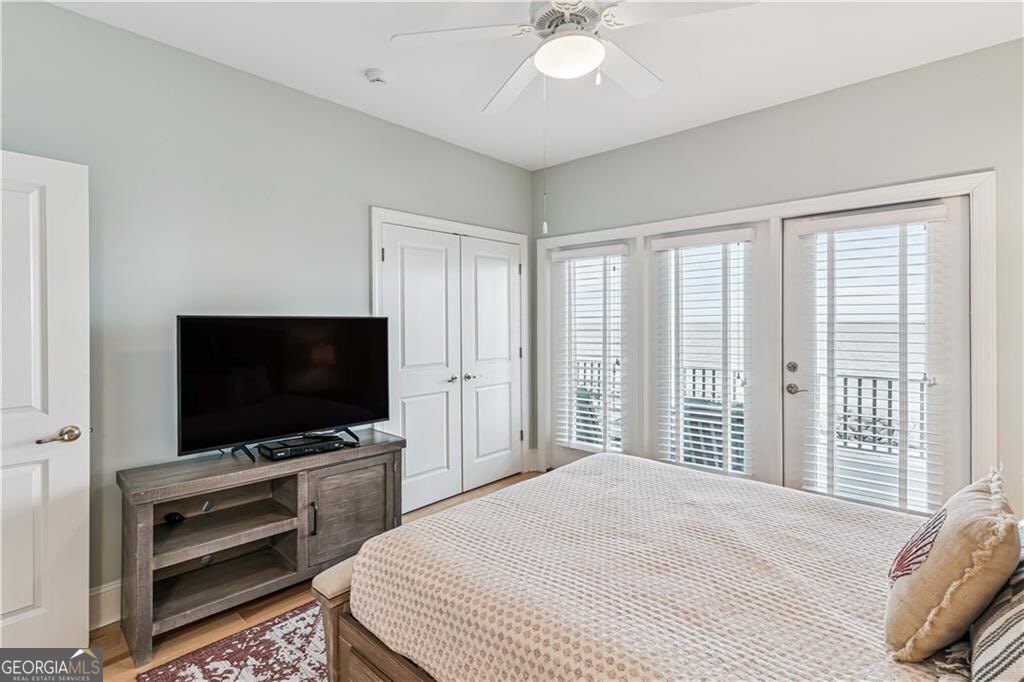 172 Turtle Track Lane, Unit OCEAN Jekyll Island, GA 31527 - Photo 26 of 51 a bedroom with a bed and a flat screen tv